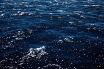 Fototapeta premium Deep blue ocean surface with small waves and whitecaps.