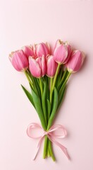 Fototapeta premium Pink tulips tied up with a pink ribbon