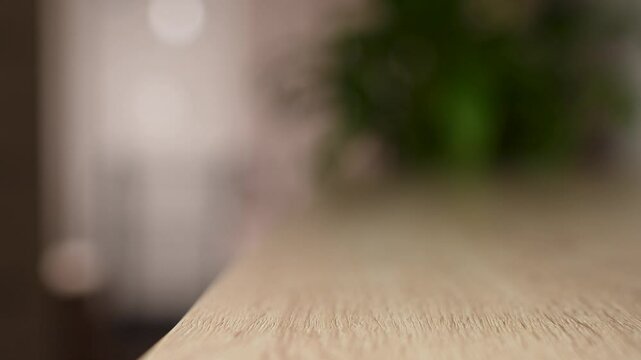 Woman putting wallet on table, close-up. Female hand puts purse while coming in room