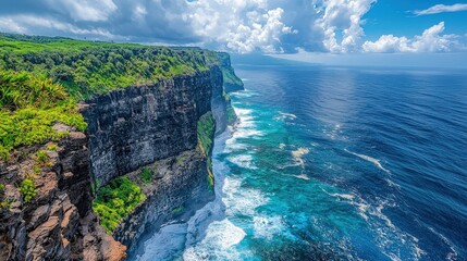 A breathtaking coastal view featuring high cliffs overlooking the vibrant blue ocean under a partly cloudy sky.