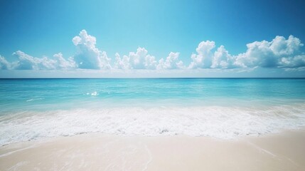 Serene beach scene with turquoise water, white sand, and fluffy clouds under a bright blue sky.