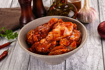 Raw marinated buffalo chicken wings