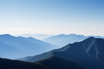 Fototapeta premium mountains with a few trees in the foreground and a blue sky in the background