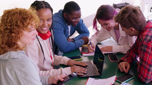 Diverse Students Collaborating on a Project with a Laptop
