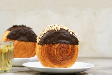 Delicious Cromboloni fusion croissants ,Round puff pastry filled with cream, topped with chocolate...