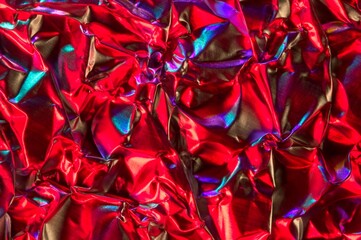 Abstract aluminum foil crumpled with colored light reflections