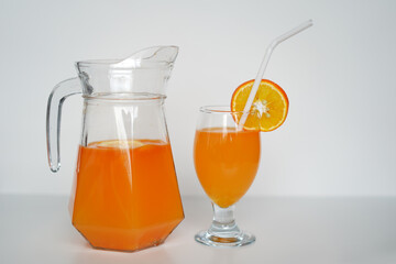 Vibrant Orange Juice in Glass Jug and Cup. Premium Stock Photo