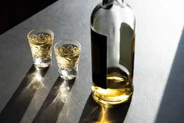 Top view of two shots of Georgian ChaCha, a traditional grape-based spirit, served in crystal...
