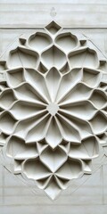 A white object with a flowery design. The flowery design is made of stone