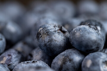 a pile of blueberries scattered on the board