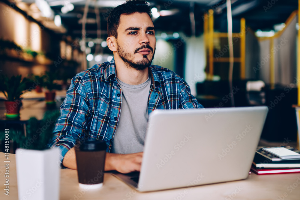 Aufkleber thoughtful male freelancer pondering on idea for working project sitting with laptop computer in cow