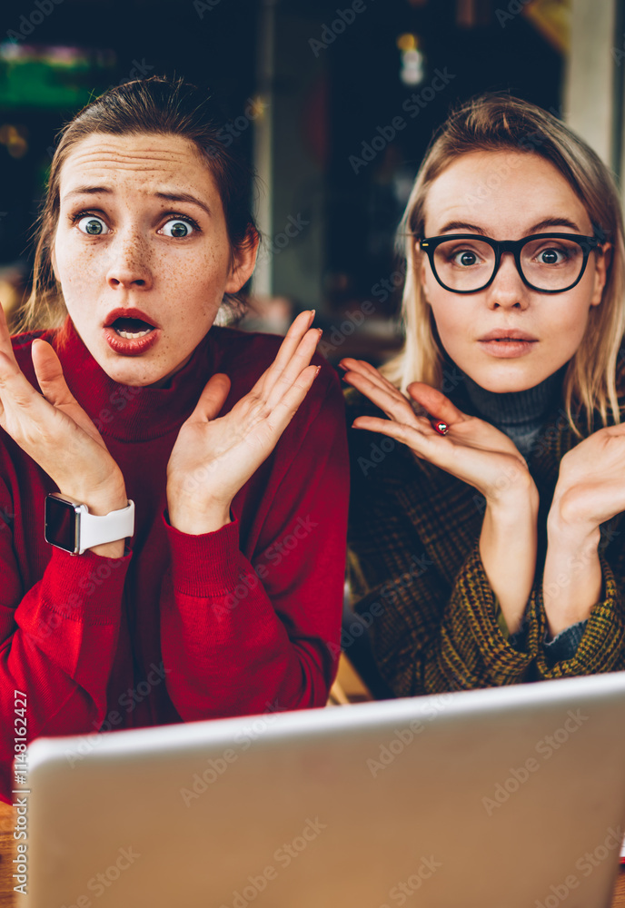 Poster half length portrait of confused two students don't know to solve studying problem at computer.puzzl
