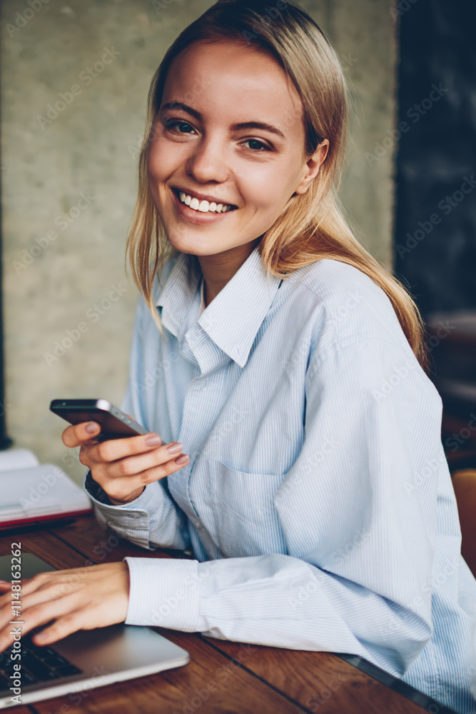 Poster portrait of successful female freelancer smiling at camera while working at laptop device using 4g i