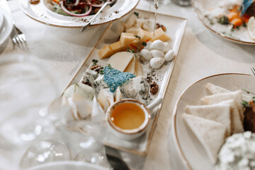 A table with a white tablecloth and a white plate of food with a blue object on it