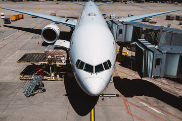 Front view of airplane at airport on sunny day. Preparation passenger plane before flight..