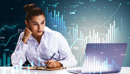 Businesswoman analyzing financial data with graphs and charts overlayed on screen.