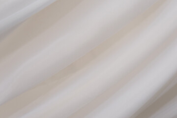 Obraz premium Soft and gentle fabric draping over a minimalist background in a well-lit space