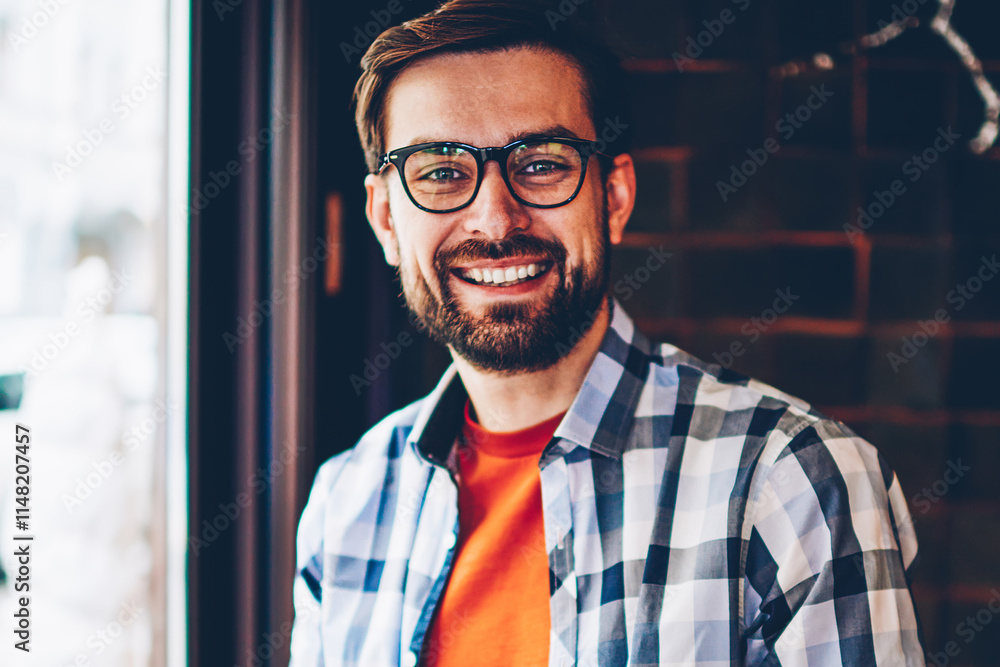 Aufkleber portrait of successful bearded hipster blogger in eyeglasses smiling at camera while updating profil