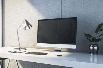 Modern workspace with computer and desk lamp on a sleek white table in a minimalistic room. 3D Rendering