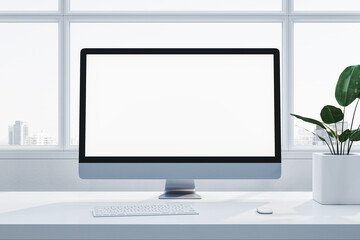 Fototapeta premium Minimalist workstation featuring a blank desktop screen, keyboard, mouse, and plant on a white desk with a city view through windows. 3D Rendering