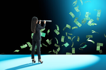 Businesswoman in spotlight observing flying money with telescope on dark stage.