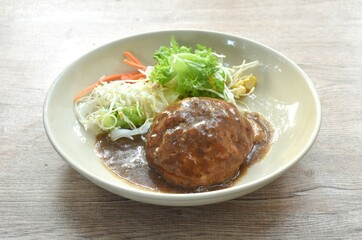 grilled chop pork steak burger dressing gravy sauce with salad on plate