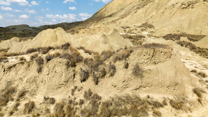Aerial view of the Calanchi near Pisticci, in the province of Matera, Basilicata, Italy. Badlands are a type of dry terrain where sedimentary rocks and clay-rich soils have been eroded away.