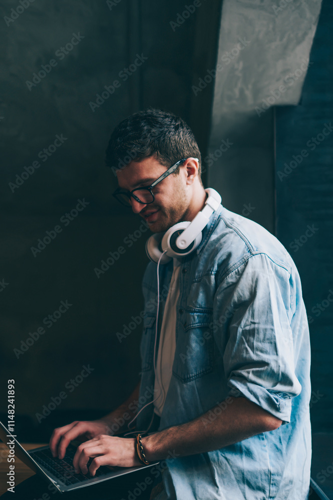 Poster happy positive hipster guy communicated in social networks using high wifi connection on new laptop 