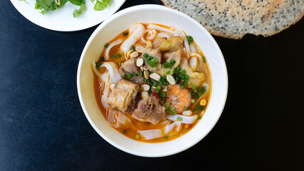 Vietnamese noodle Mi Quang. Mi Quang, Vietnamese rice noodles with meat, chicken stock, shrimp,...