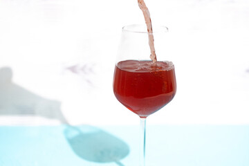 red wine pouring into glass
