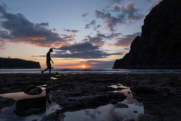 silhouette of person on the beach at sunset