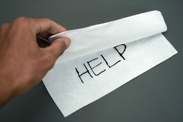 Hand opens a tissue cupboard with the words help, concept of assistance, asking for help, in danger