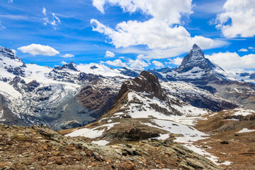 Scenic view on snowy Matterhorn mountain peak in sunny day with blue sky in Switzerland. Beautiful nature background of Swiss Alps covered with snow. Famous travel destination