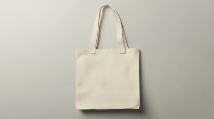 Off-white canvas tote bag on gray background.