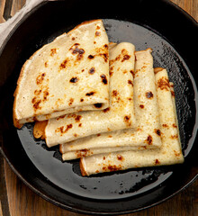 Crepes with sweet toppings on dark background.