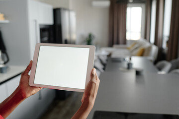 High angle shot of unrecognizable woman holding touchpad with white screen