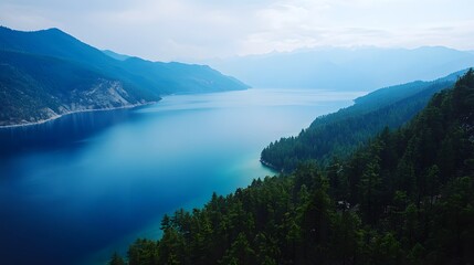 Fototapeta premium Aerial shot of the serene Lugu Lake in Yunnan, with its deep blue waters surrounded by dense forests, in 4K resolution
