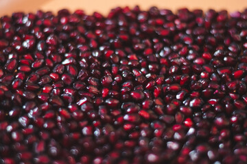 Fresh pomegranate seeds as a background.
