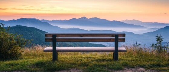 Obraz premium a wooden bench with mountains in the distance and morning sky