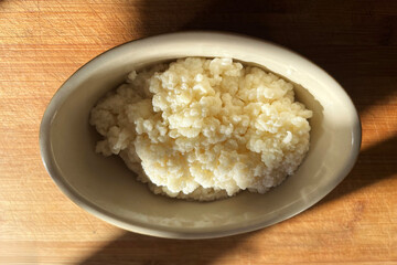 Milk Kefir grainbs in a rustic oval bowl after being rinsed and ready to add to milk and fermented to make some delicious kefir yoghurt. Kefir is also known as kephir or kefier