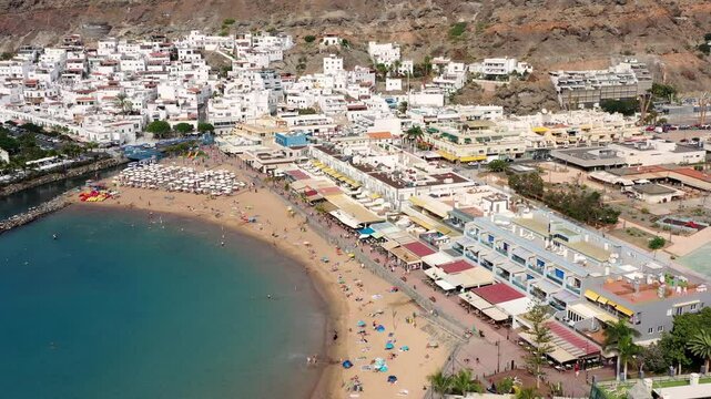 Puerto de Mogan with the beach in Gran Canaria, Spain. Favorite vacation place for tourists and locals on island. Harbor in Puerto de Mogan and Playa Mogan on Grand Canary Island, Spain.