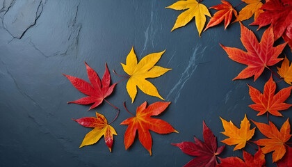 "Autumn background featuring vibrant red leaves arranged on a blue slate surface. Top view with ample copy space."