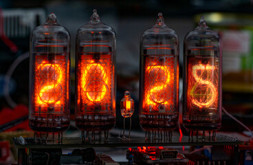 retro Nixie lamp indicator clock on dark background 2025 number