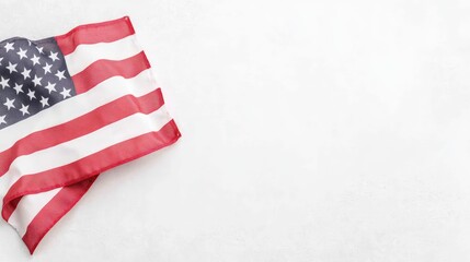 Obraz premium American flag folded in the corner of a textured white background with copy space.