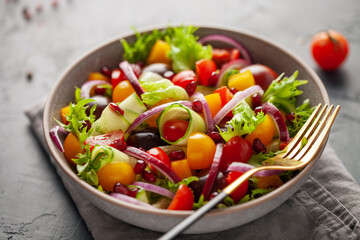 Easy vegetarian salad of fresh cucumber, tomato, sweet pepper,  onion  with pomegranate seeds. Healthy food.