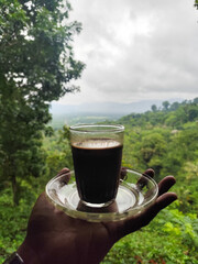 A cup of coffee while enjoying the beautiful mountain view.