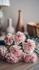A microstock photo of a delicate bouquet of carnations in soft shades of pink and white, creating an abstract image background
