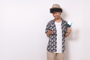 young travel man standing,  holding passport and phone with smile isolated on white background.