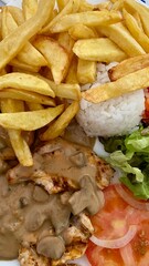 traditional portuguese cuisine, fish, meat with mushrooms, salad and fried potatoes and rice