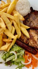 traditional portuguese cuisine, fish, meat with mushrooms, salad and fried potatoes and rice